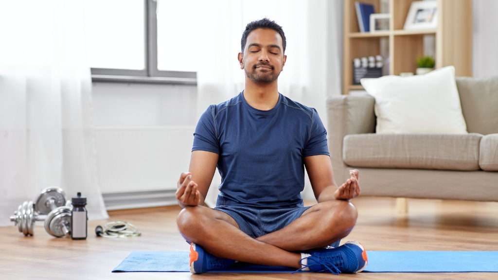 A person is practicing yoga, which is an effective way to prevent physical fatigue.